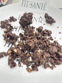 a plate of chocolate granola with the words fit sante on it