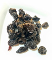 dried plums on a white plate