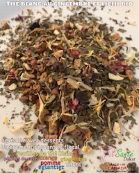 a pile of dried herbs and flowers on a white plate