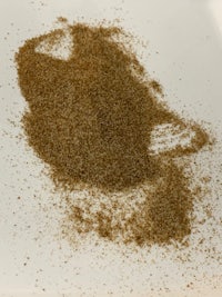 a brown powder on a white plate