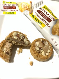 a plate with two cookies and a bar of chocolate
