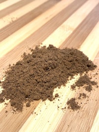 a pile of dirt on a wooden table