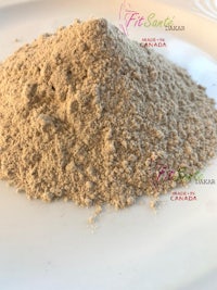 a pile of brown powder on a white plate