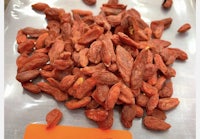 a pile of dried goji berries on a table