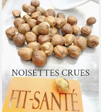 nuts on a cutting board with the words noisettes crues