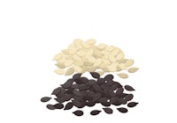 a pile of black and white seeds on a white background