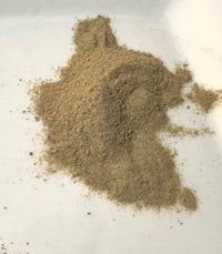 a pile of sand on a white plate