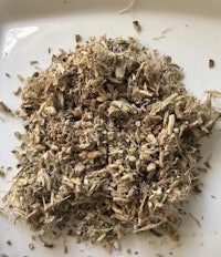 a pile of dried herbs on a white plate