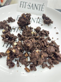 a plate of chocolate covered nuts with the words fit sante on it