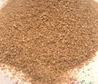 a bowl of brown powder in a white bowl