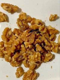 a plate of walnuts on a white plate