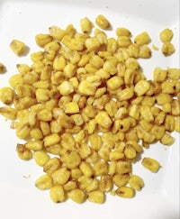 roasted corn on a white plate