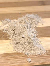 a pile of sand on a wooden table