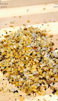 a pile of spices on a wooden cutting board