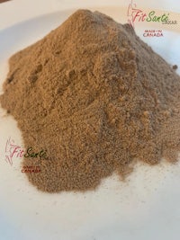 a pile of brown powder on a white plate