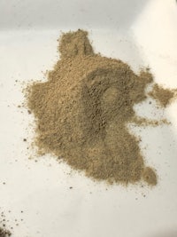 a small pile of sand on a white plate