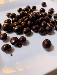 chocolate covered almonds on a white plate