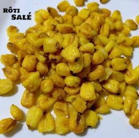 a white plate with yellow corn on it