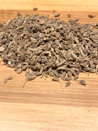 a pile of dried seeds on a wooden table