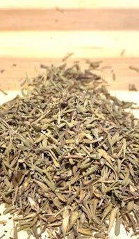 a pile of dried leaves on a wooden table