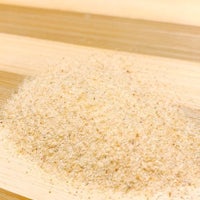 a pile of flour on top of a wooden cutting board