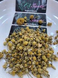 chamomile flowers on a white plate