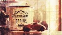 a coffee mug with the words the adventure begins on it