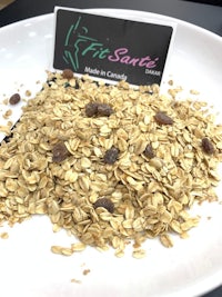 a plate of granola with raisins on it