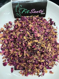 a bowl of dried rose petals on a table