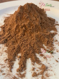 a pile of chocolate powder on a white plate