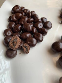 chocolate covered almonds on a white plate