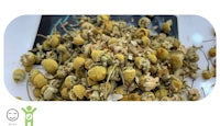 a pile of dried chamomile flowers on a table