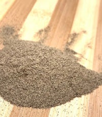 a pile of brown powder on top of a wooden table