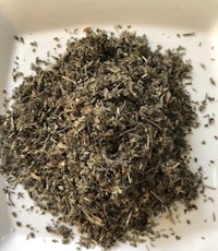 a pile of dried herbs on a white plate