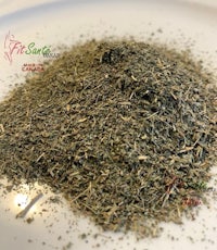 a pile of dried herbs on a white plate