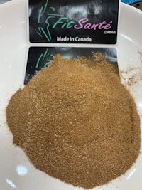 a pile of brown powder on a white plate