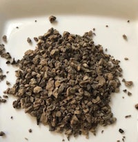 a pile of dried herbs on a white plate