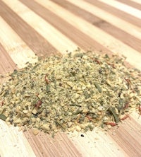 a pile of herbs and spices on a wooden cutting board