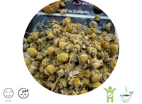 a pile of dried chamomile flowers on a white background