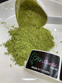 matcha powder on a white plate with a scoop