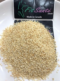 a bowl of sesame seeds with a label on it