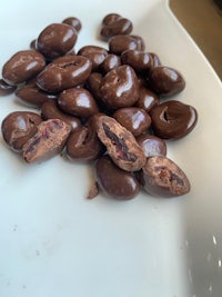 a plate of chocolate covered coffee beans on a table