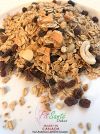 granola with raisins and nuts on a white plate